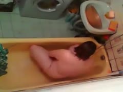 Unaware that the cam is concealed, a mature wife masturbates in the bathroom.